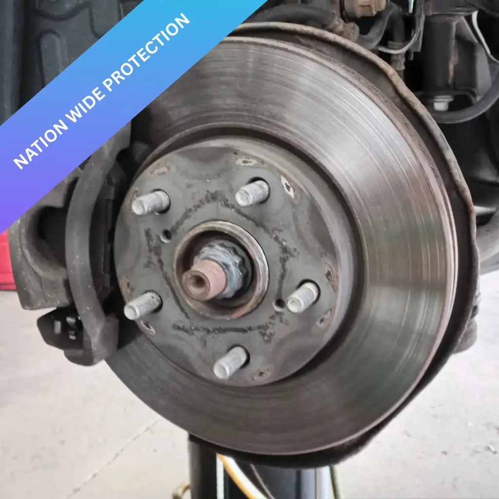 Worn brake pads and rotor showing signs of damage